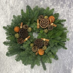 Festive Spice Fresh Christmas Wreath. The Kilted Christmas Tree Co Festive Spice Fresh Christmas Wreath is a fantastic mixture of dried fruit, lotus heads, cinnamon sticks, and cones. Its Highland Scottish noble fir delivers a beautiful scent to enhance your festive home. Handmade in Kinross The sizing relates to the circumference of the metal wreath ring, add approximately another inch on either side for the lush foliage. Sizing may vary slightly.